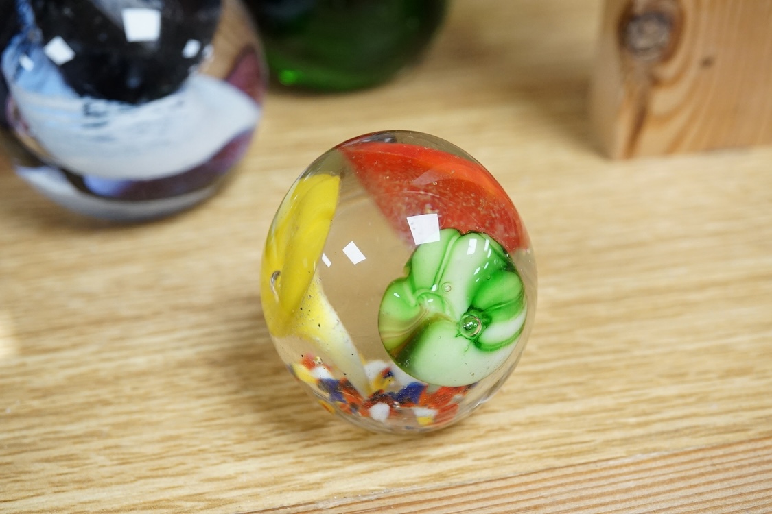 A collection of glass paperweights to include Caithness and millefiori examples, largest 10cm high